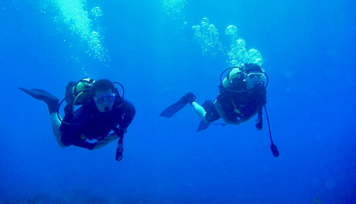 Student hovering underwater during scuba certification training